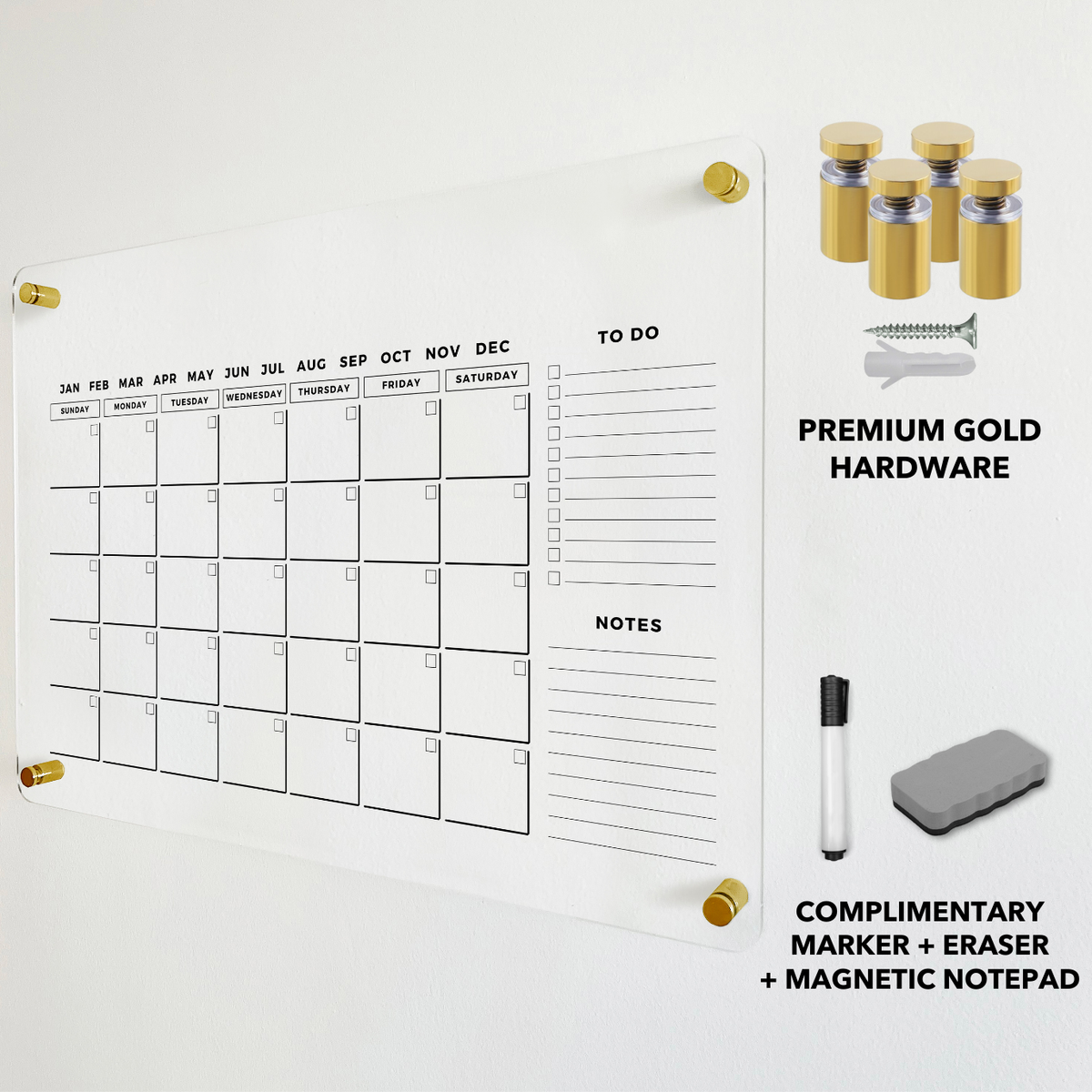 Clear monthly calendar with gold mounting hardware and a dry-erase eraser displayed beside the board.