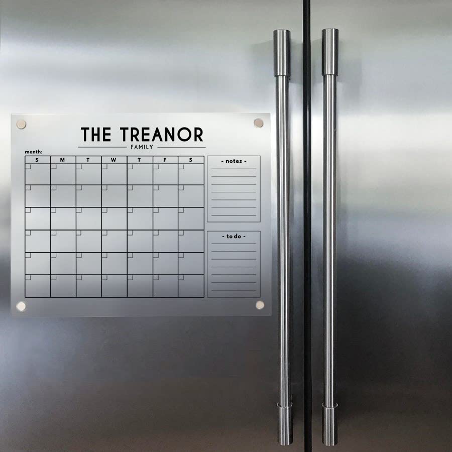 Magnetic acrylic family calendar with two side lists displayed on a stainless steel double-door refrigerator.