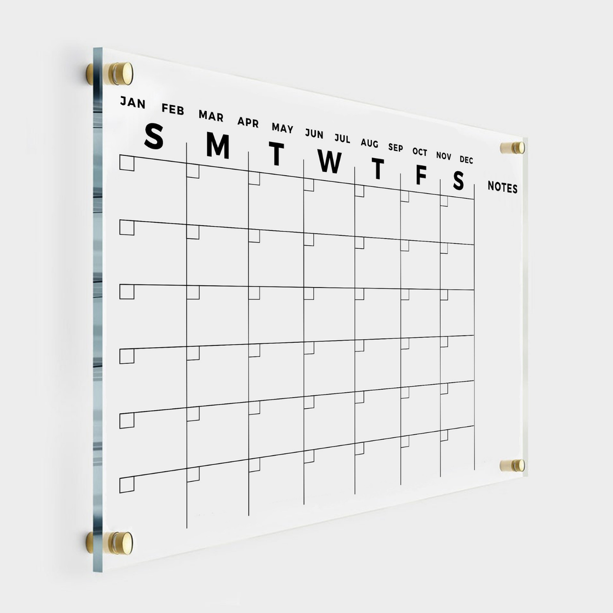 Angled view of an acrylic monthly calendar with bold day initials, a narrow open Notes column and gold mounts.