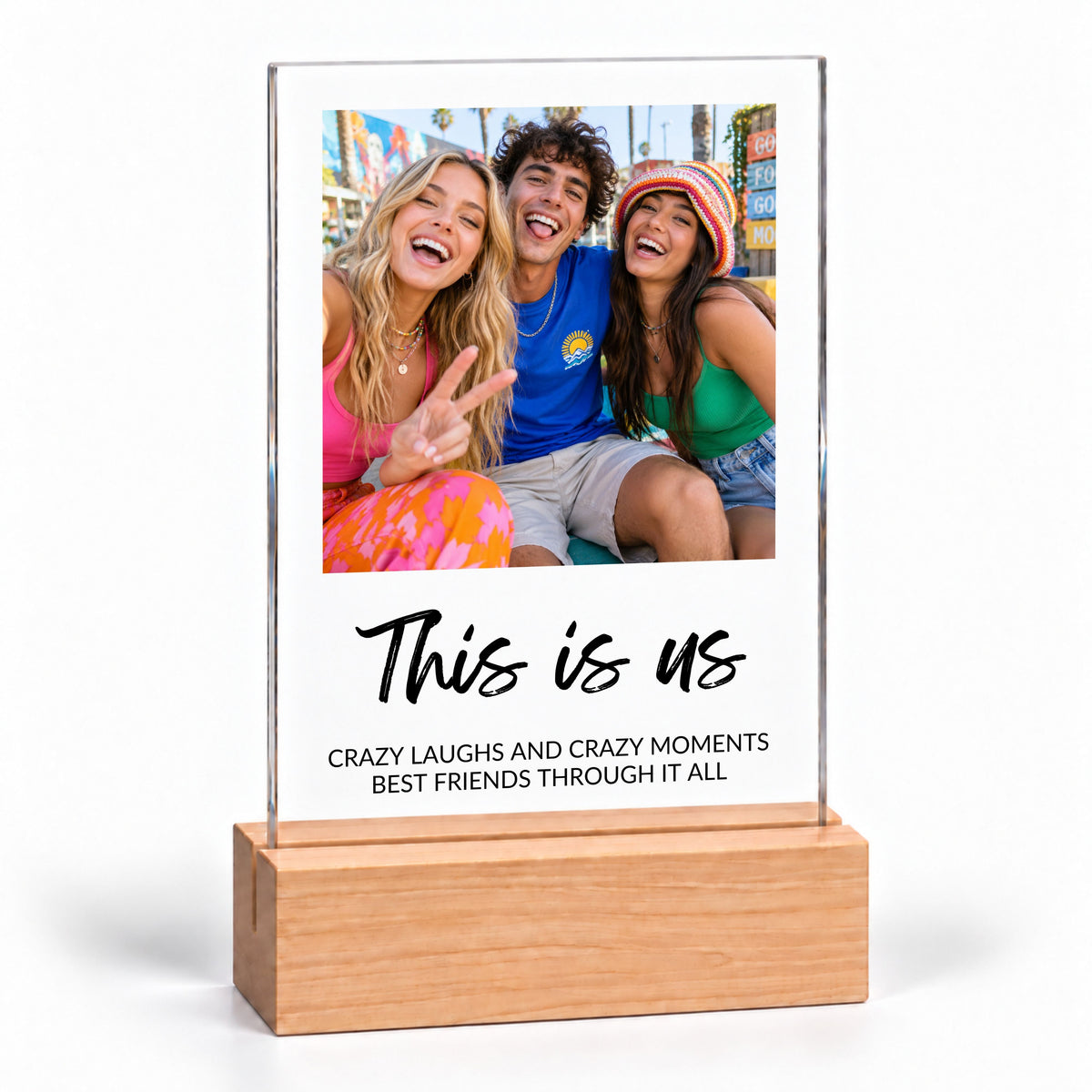 Clear acrylic Photo Collage Plaque - Brush Script on a plain wooden stand with the sample text This is us, on white