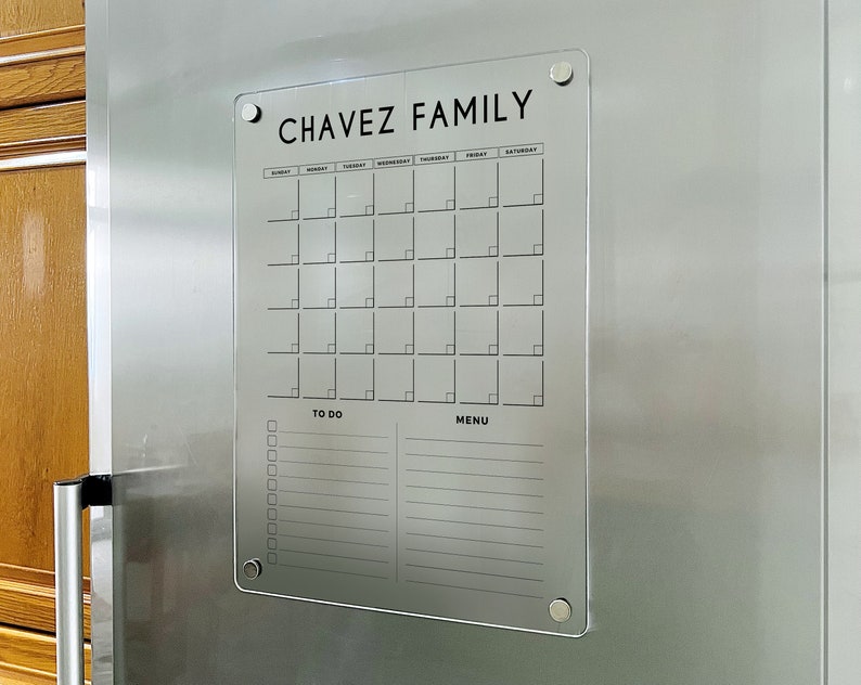 Magnetic acrylic fridge board with a monthly grid above two lined sections for to-dos and meal planning.