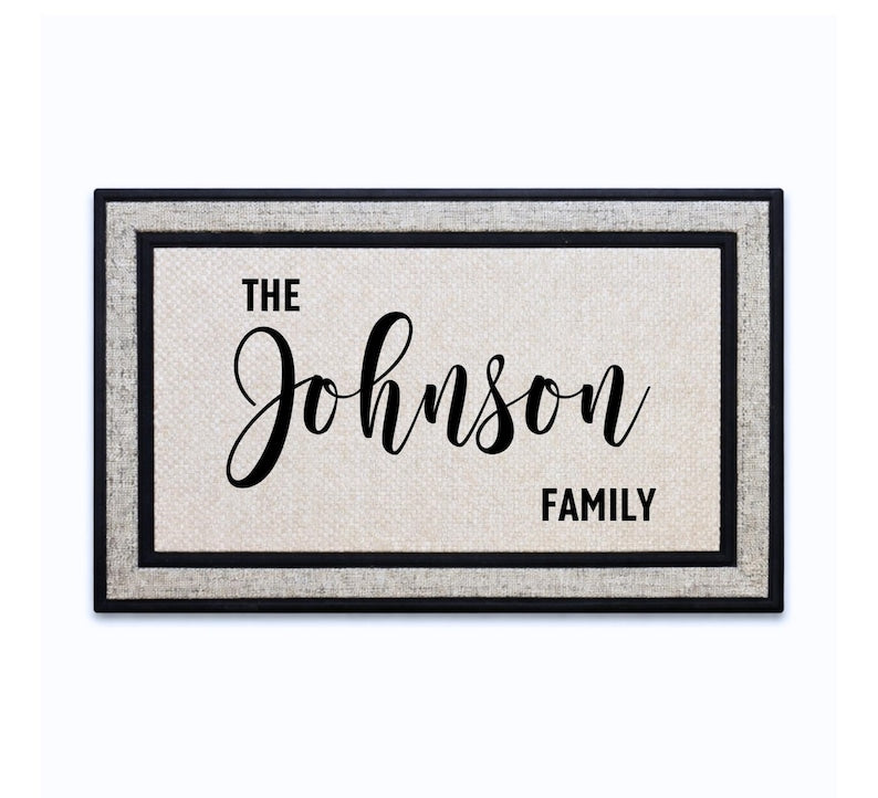 18 x 30 inch polyester doormat featuring a large script surname with THE and FAMILY accents.