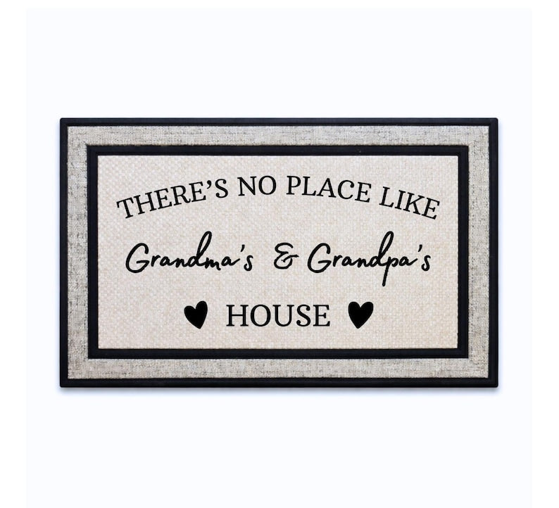 18 x 30 inch polyester doormat featuring arched THERE’S NO PLACE LIKE text, personalized grandparent names and heart accents.
