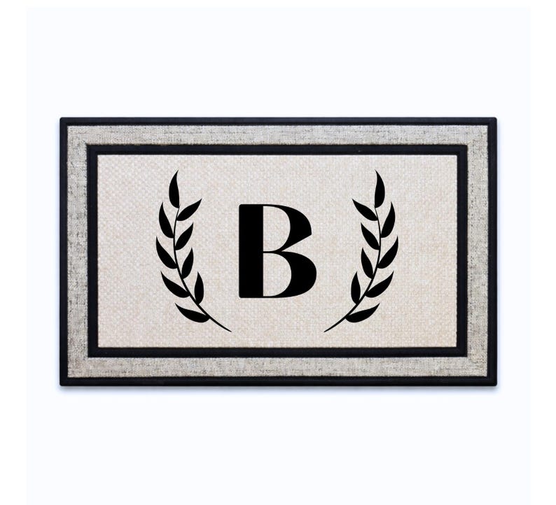 18 x 30 inch polyester doormat featuring a single initial framed by laurel branches.