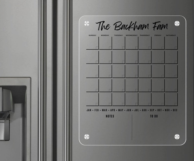 Magnetic acrylic fridge board with a monthly grid above notes and to-do sections, with a rounded border.